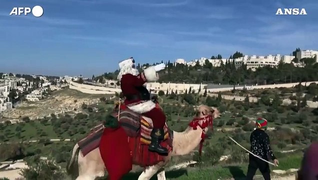Israele, Babbo Natale sul cammello per le strade di Gerusalemme