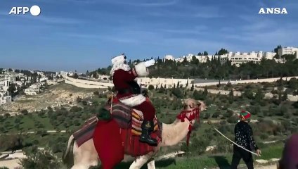 Israele, Babbo Natale sul cammello per le strade di Gerusalemme