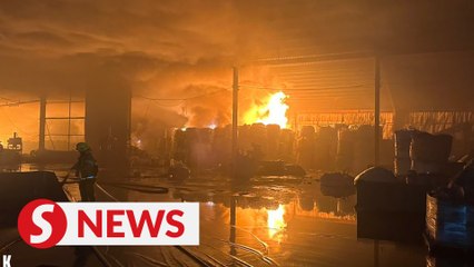 Hazmat team monitoring fire site