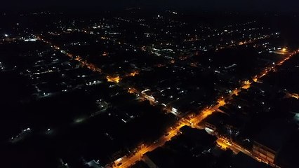 An Aerial View Flying Over A Thailand City At Night.