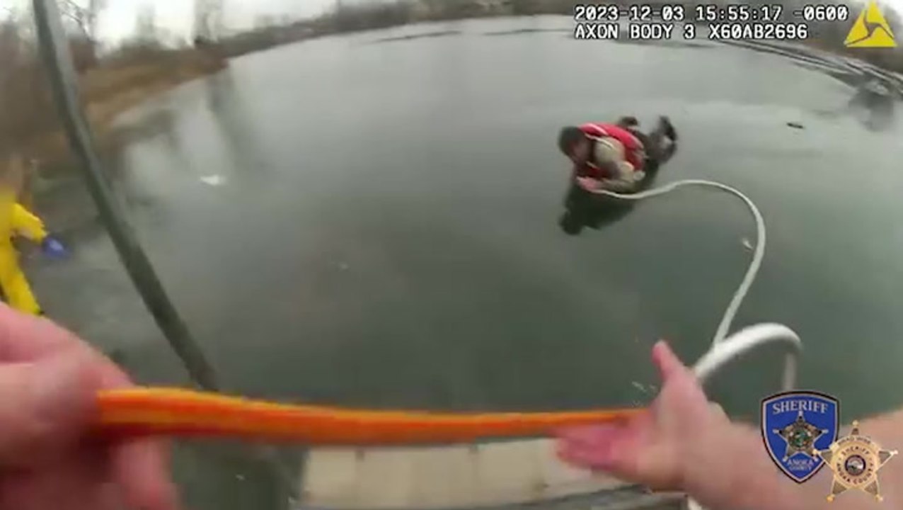 Police officer crawls across frozen lake to rescue two fishermen and their dog