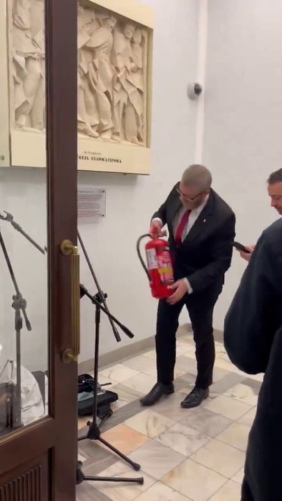 Polish MP Grzegorz Braun extinguishes Jewish Hanukkah candles at Poland's parliament.