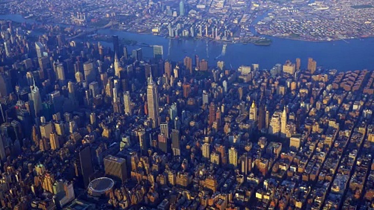 Aerial flyover of downtown New York city at sunset.