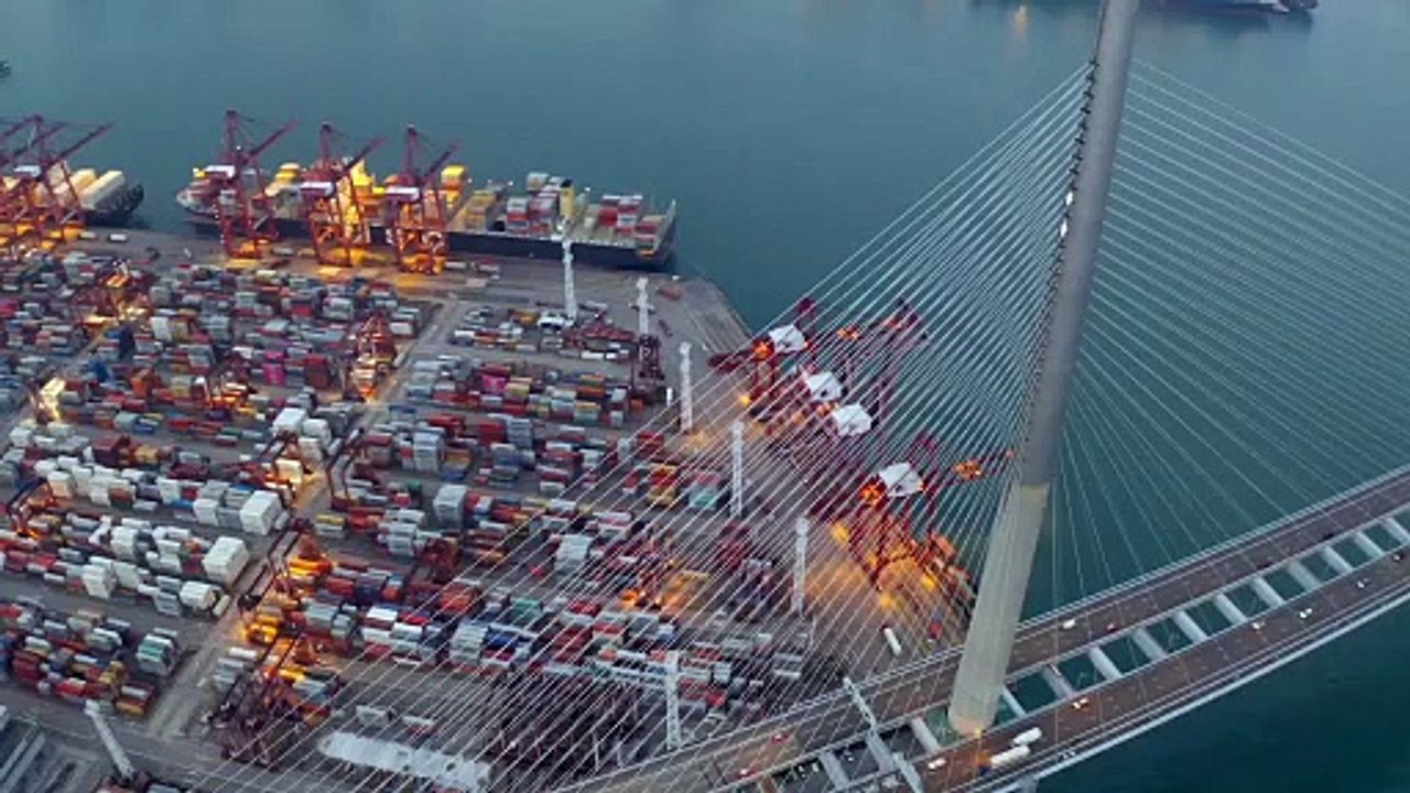 Stonecutters Bridge in Hong Kong and Container Cargo freight ship.
