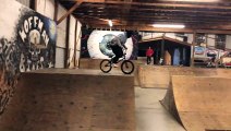 BMX rider jumps off top of half pipe at skatepark and faceplants