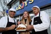 Reporter Megan Jones taste tests the new masala flavoured chips at Arjy's takeaway in Trench, Telford.