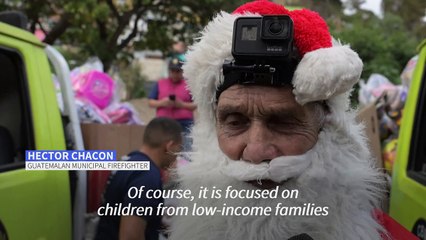 Santa firefighter rappels gifts down a bridge for Guatemalan kids