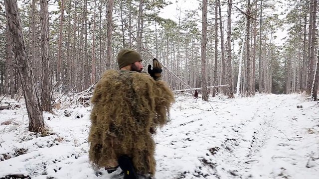 Soldiers Lie Down On The Ground, Aiming Through The Sight Of An Assault Rifle