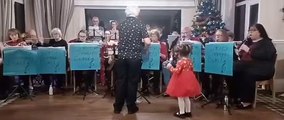 Little girl joins in with Christmas orchestra