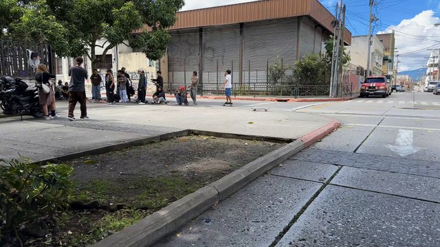 Skateboarder goes kickflip over gap then falls forward and bumps head into wall