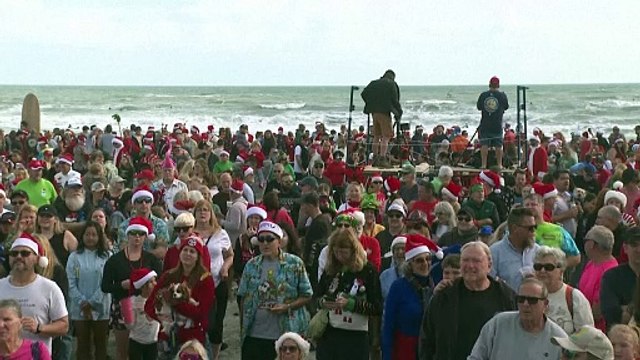 Surfing Santas ride waves, raise funds in Florida