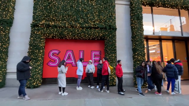 Shoppers queue outside Selfridges on Oxford Street