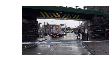 Police called after lorry gets stuck under bridge damaging roof