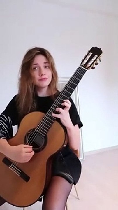 Can you guess the tune she's strumming