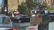 A man begs in the street in a smart and funny way