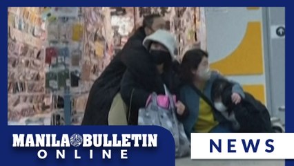 UGC: Shoppers huddle together as earthquake hits Japan