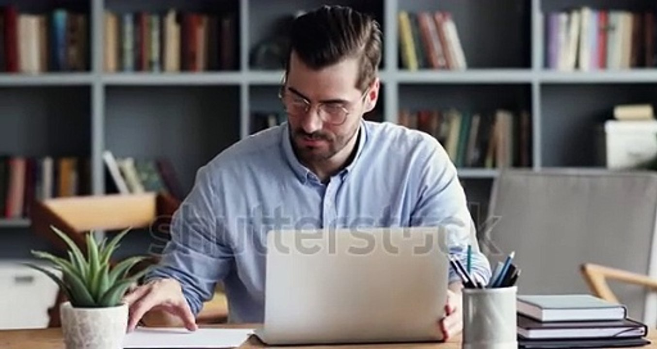 stock-footage-focused-business-man-entrepreneur-typing-on-laptop-doing-research-young-male-professional-using