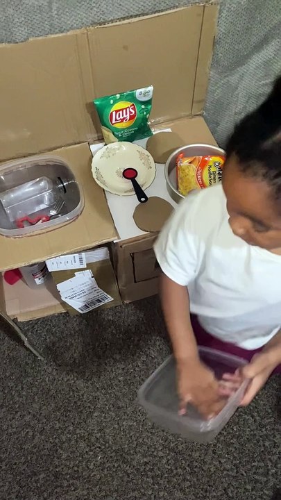 Girl Gets Cookin' in Cardboard Kitchen