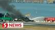 Smoke rises from Japan Airlines flight wreckage as removal underway