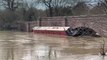 Storm Henk flooding traps canal boat against bridge as river swells