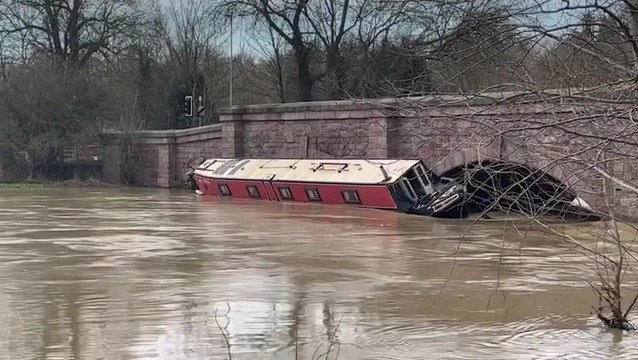 Storm Henk flooding traps canal boat against bridge as river swells