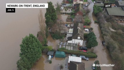 River spills into homes as flood threat remains in England