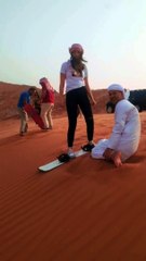 Sandboarding in Dubai safari desert with Al Qudra Tours