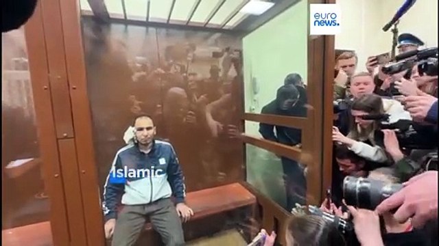 Four bruised and bloodied men charged over Moscow concert attack