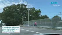 Dirt bike seen riding along bridge footpath at Broadmeadow Road in Newcastle