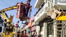 Bulldozer runs on encroachment on footpath and drain