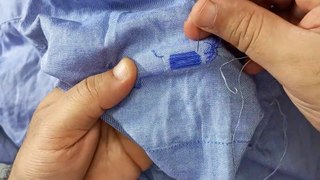 Repairing a cut in a shirt and re-sewing it again in an amazing way.