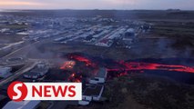 Drone footage shows molten lava burning houses in Iceland