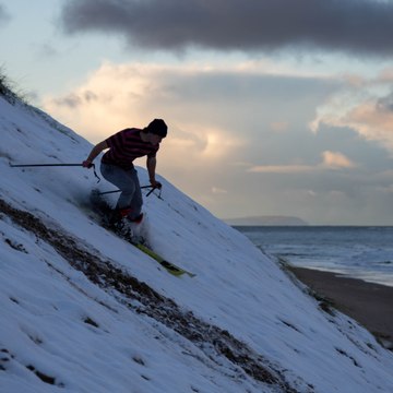 Snow way: Watch as skiers take to the snowy sand dunes on the north coast