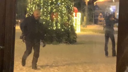 City cloaked in crystal: People dance through diamond dust on the street