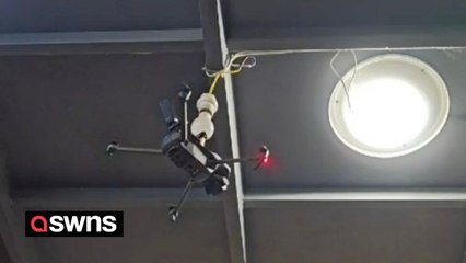 Bizarre moment man uses a drone to screw in a lightbulb