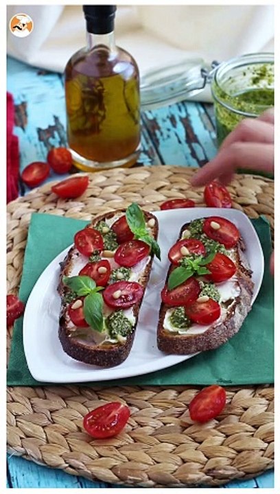 Fresh cheese, pesto, and cherry tomato toasts