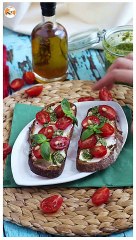 Fresh cheese, pesto, and cherry tomato toasts