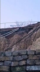 Water seen pouring out above a cliff collpase