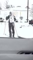 Person Uses Skiis to Traverse Snow Covered Streets