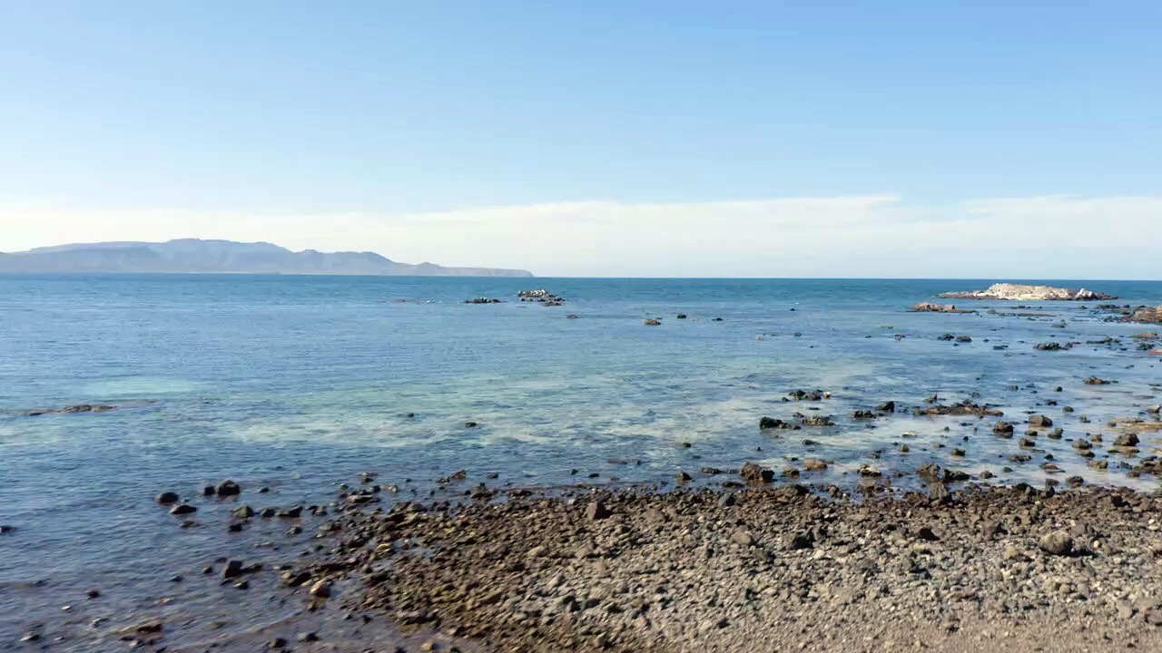 View of the sea and the horizon from a rocky beach
