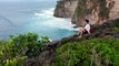 Man looks over cliff edge to sea on Bali Indonesia