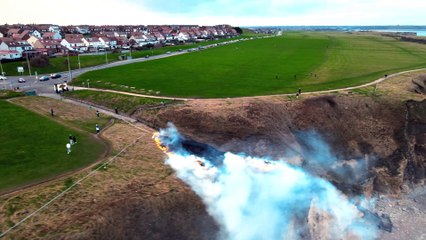 Drone footage shows a grassland fire at Marsden Cliffs