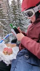 Skier Enjoys a Meal on Chairlift