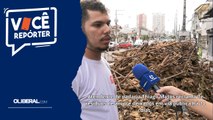Atendente de padaria Thiago Matos reclama de resíduos de árvore deixados em via pública há 14 dias