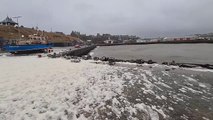 Sea foam like snow floating by Wick harbour on Saturday, February 10, 2024 .