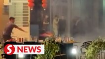 Burning firecrackers thrown at a lion dance troupe in Sandakan