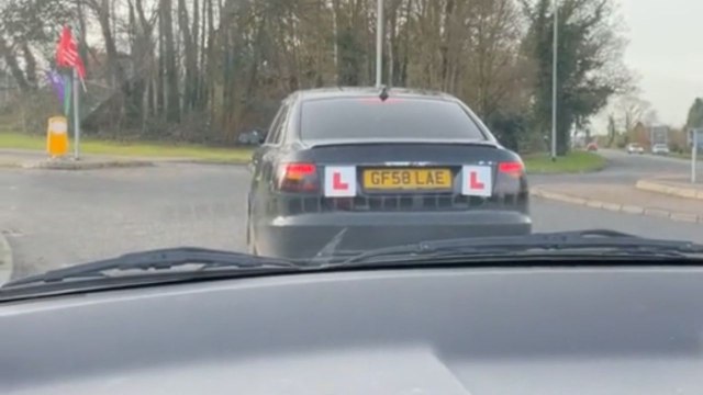 Women cheer from inside their car when an amateur driver manages to drive on
