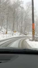 Car Slides Into Snowy Ditch