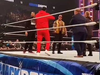 Roman reigns watch as The Rock hugs Jimmy Uso after WWE Smac