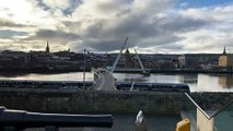 Train passing by Ebrington and the Peace Bridge in Derry's Waterside